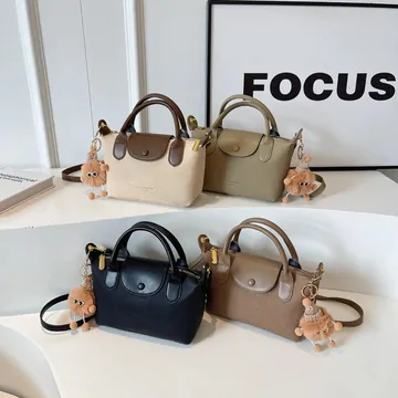 Seller display photograph of four bags with attached decorative charms.