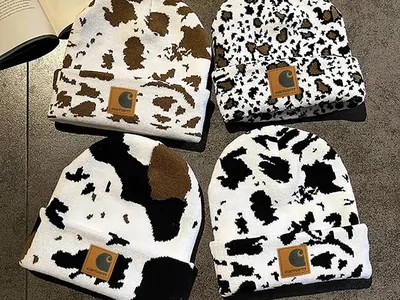 Black and white patterned knitted beanies with small square patches